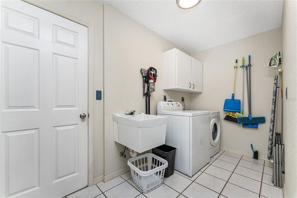 Large Laundry Room Has Utility Sink And Upper Cabinetry!