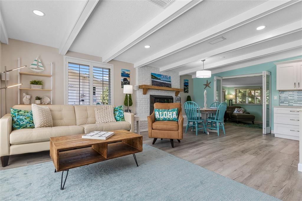 This view shows the OPEN floor plan in this home.   Gorgeous Luxury Vinyl plank flooring runs thru most of this home and the color palette is beachy, light and bright!