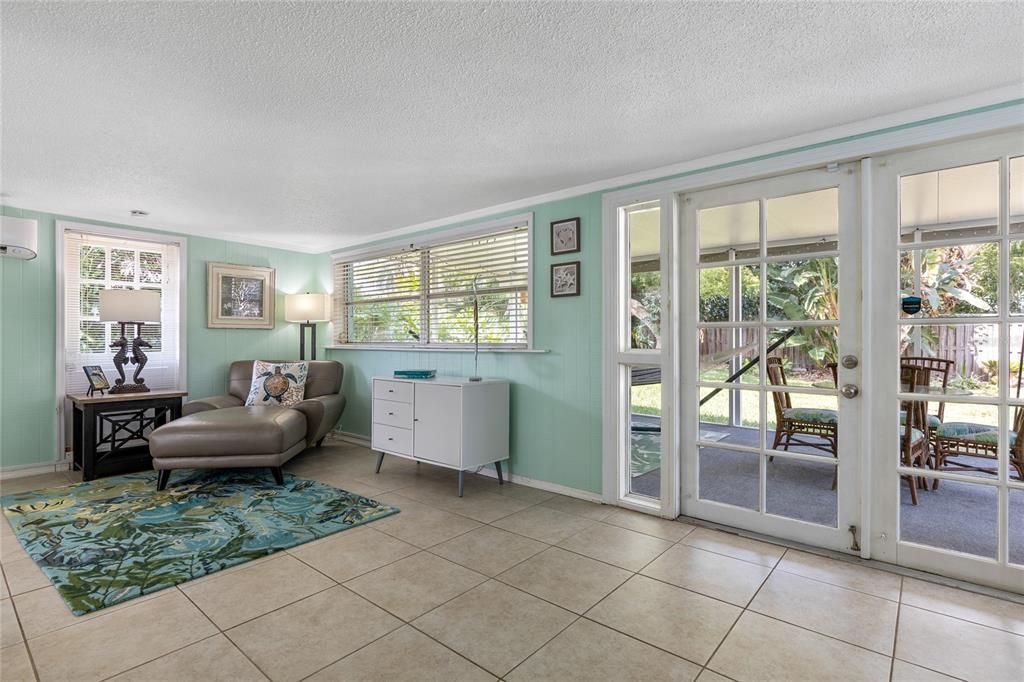 This view in the Florida Room shows the French doors leading out to the screened, covered lanai.