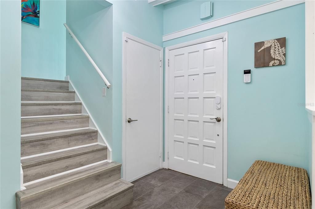 As you enter the home, the foyer has steps leading up to the bedrooms and thru the door steps down to the Garage.