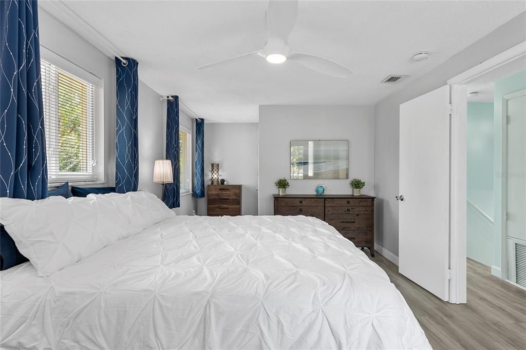 The Primary bedroom is ample sized with large windows and the same beautiful Luxury Vinyl floors as downstairs.