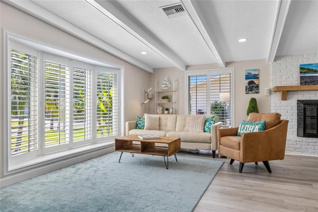 The Great Room welcomes you in to this home with floor to ceiling windows and beautiful plantation shutters to let you control just how much light comes in.