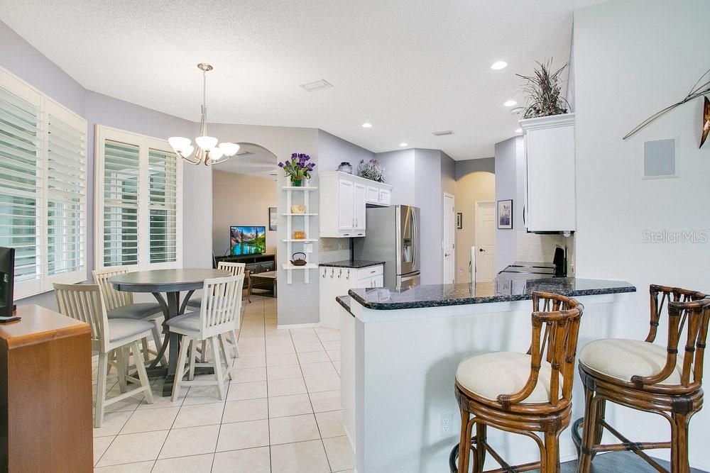 Kitchen with eating space, granite counters, snack bar, stainless steel appliances, walk-in pantry