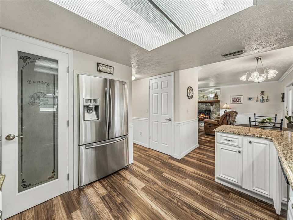 Kitchen with glass-front door of pantry