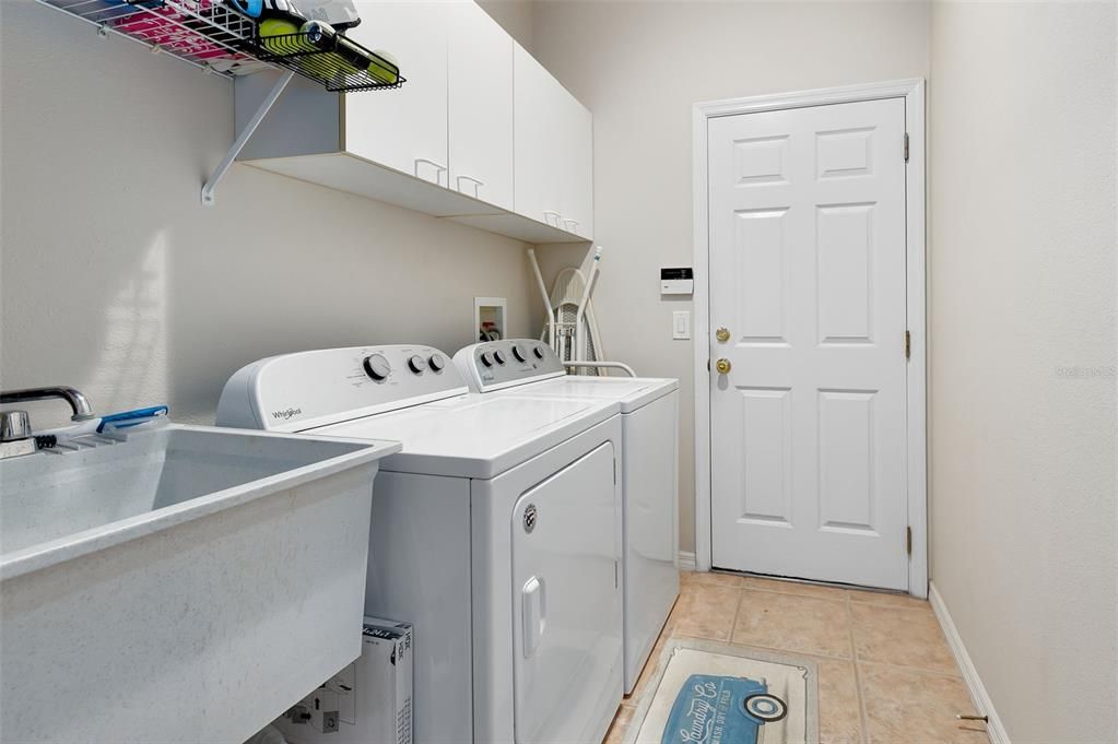 LARGE LAUNDRY ROOM WITH WASH TUB AND STORGE CABINETS