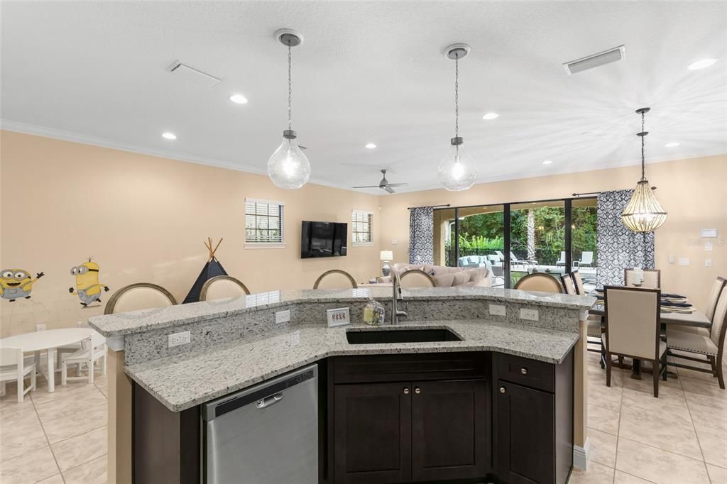 Open concept kitchen to living and dining areas with eat in area including barstools