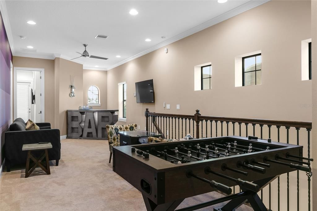 Loft gameroom complete with sitting area and gaming table