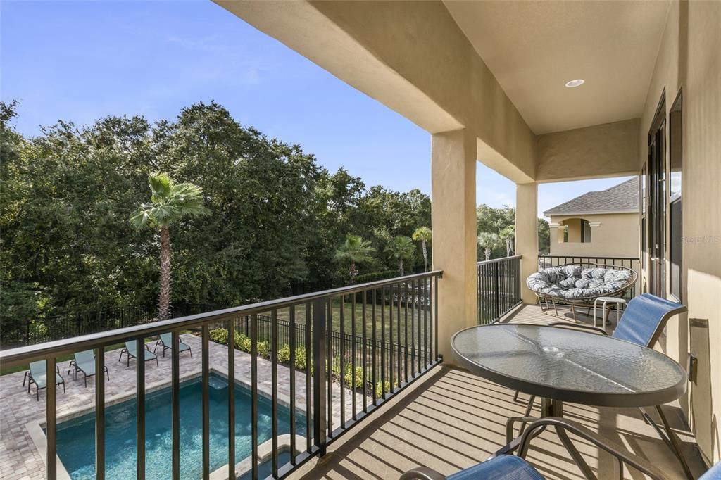 Upper level primary bedroom patio overlooking pool