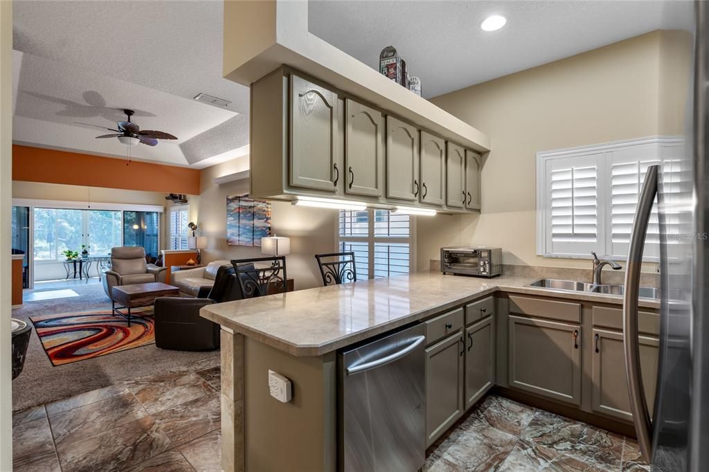 Open kitchen with stainless appliances.