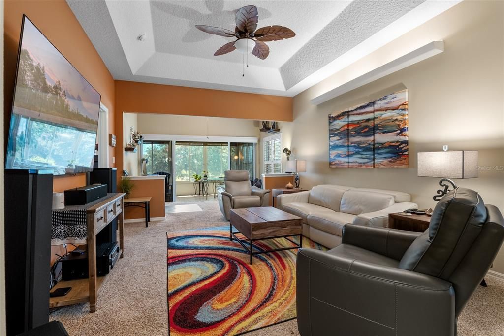 Spacious family room with dramatic tray ceiling.