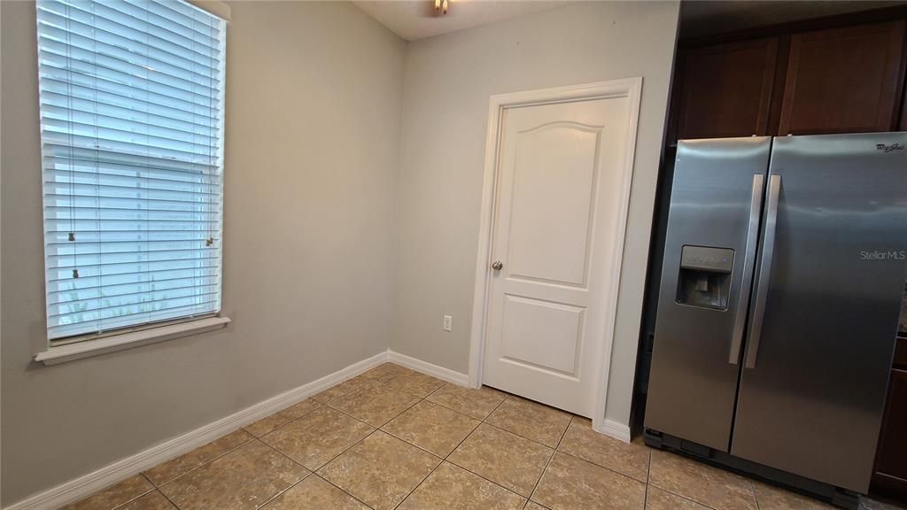 Eating space in kitchen.  Door leads to the laundry room and the garage.