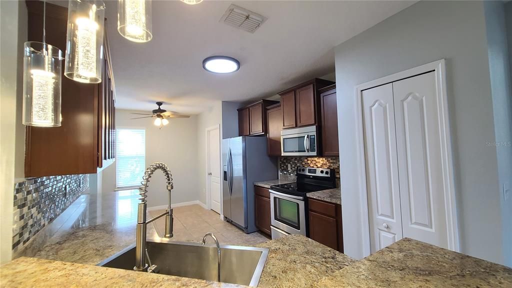 The breakfast bar has room for several chairs and overlooks the beautiful kitchen.