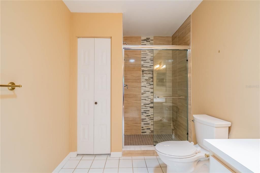 CUSTOM TILED SHOWER WITH GLASS DOORS