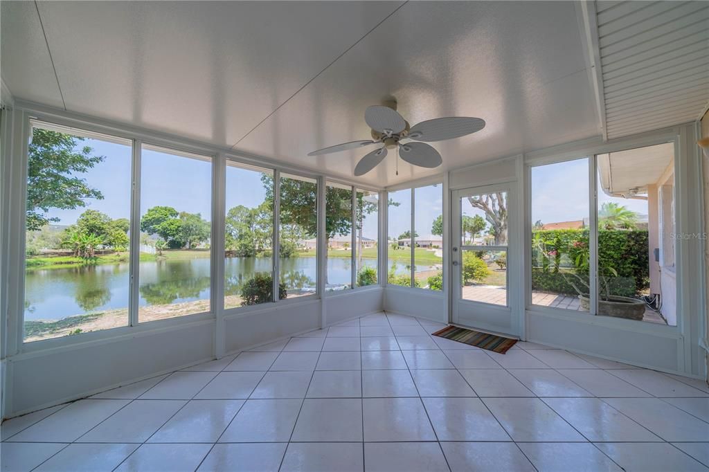 BREATHTAKING GLASS ENCLOSED FLORIDA ROOM WITH BRICK PAVER PATIO JUST OUTSIDE THE DOOR