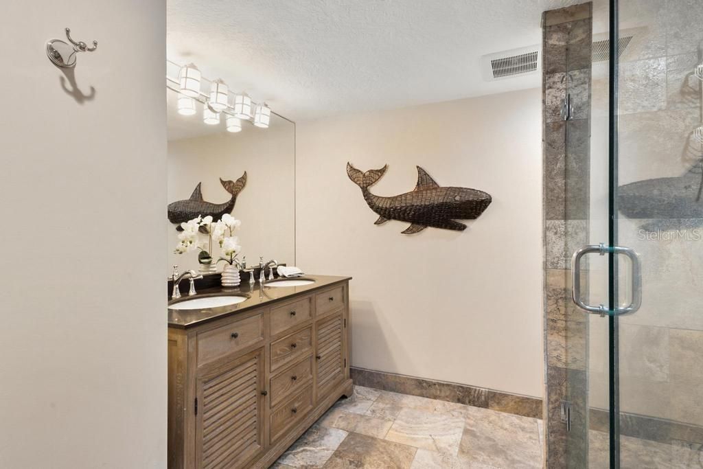 Travertine bathroom, designer cabinetry