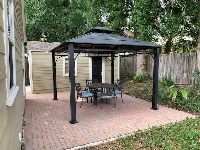 private gazebo with pavers and patio set