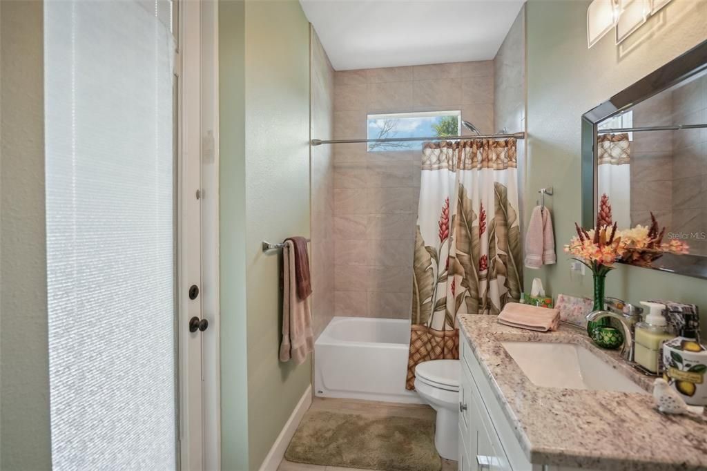 Guest bathroom with exit to pool area