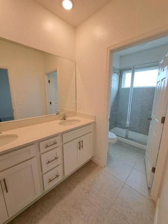 Master Bathroom - Dual sinks in Vanity and separate room for commode and shower.