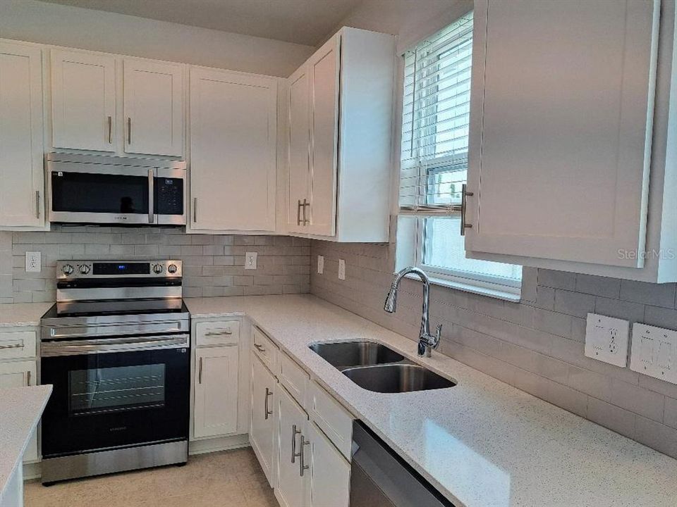 Kitchen - This Kitchen will be the hub of the home, and you will never miss a moment while completing tasks here.