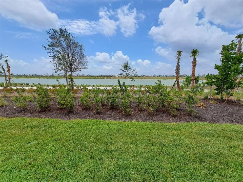 View - Lake view from the back yard. You are steps from the walking trail that passes behind the home