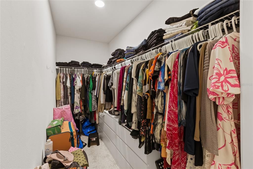 Master walk in closet with space for lots of items.
