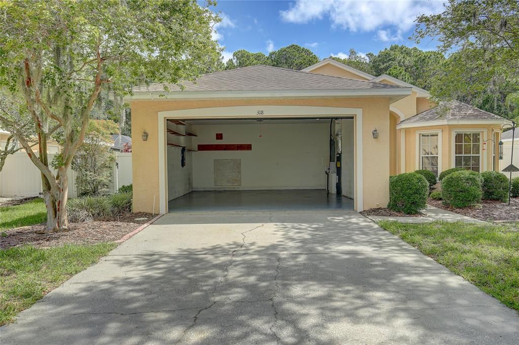 An oversized two-car garage is 26 feet in length with an eight-foot high door and higher ceiling. Having plenty of space for boat or car parking and storage. Home of the 2021 AC and 2018 water heater.