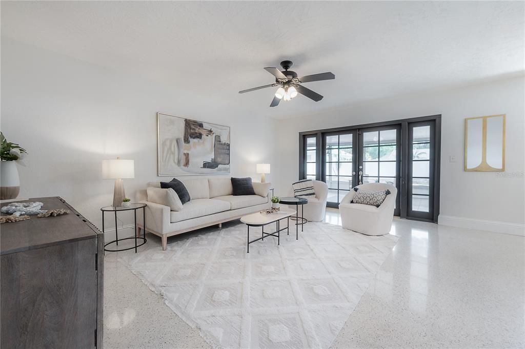 Living room with french doors leading to screened lanai