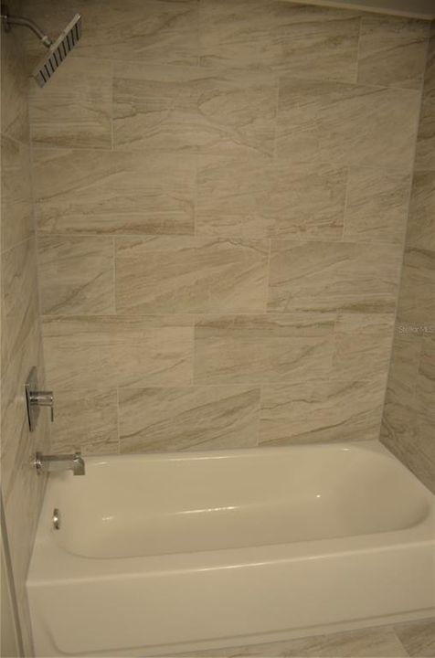Brand new oversized shower tiles, tub, shower fixtures