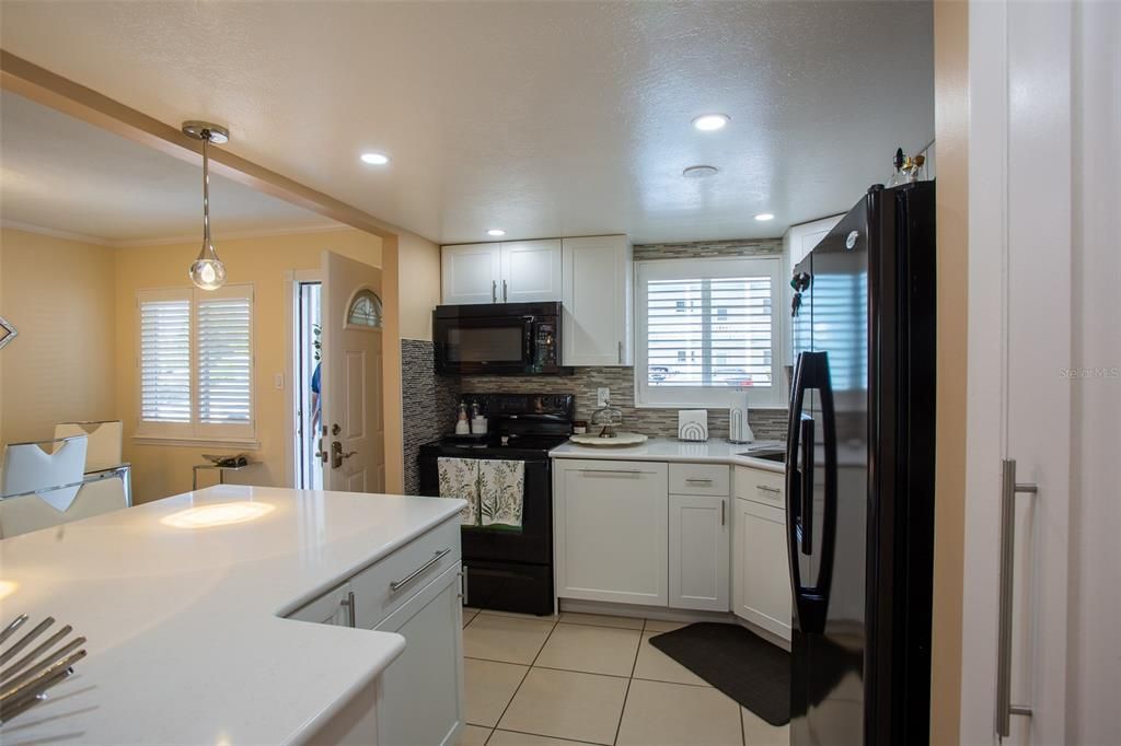 Matching wood panel covers the dishwasher in center of frame.