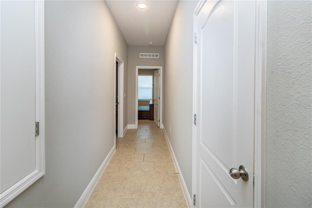 Hallway to laundry and private guest bedroom