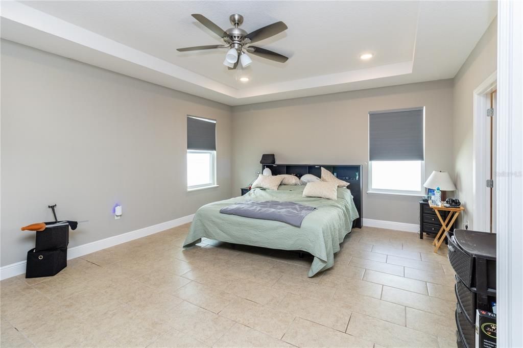 Large primary bedroom with trey ceilings.