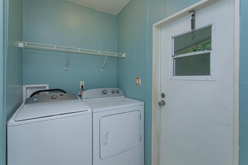 Indoor laundry room with access to the back yard