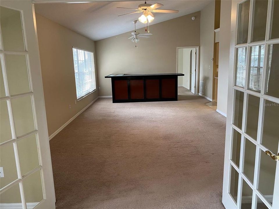 Den looking into living room/dining room. Dining rm is where that bar furniture is in the pic