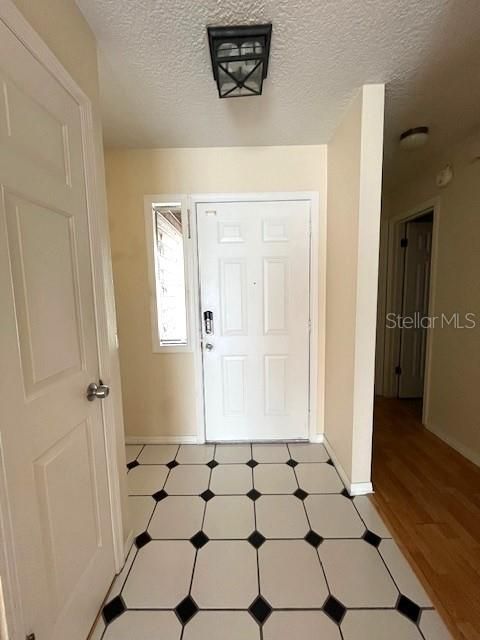 Foyer has ceramic tile and a coat closet