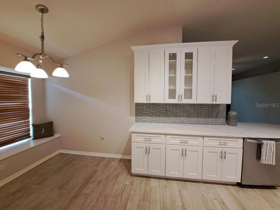 Cabinets and dinette area with window seat