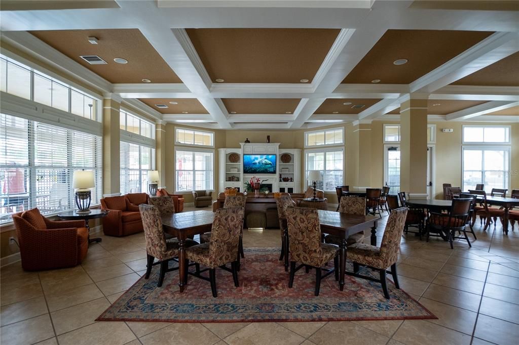 Clubhouse sitting area boasts a TV, billards table, kitchen, sofas, and tables.