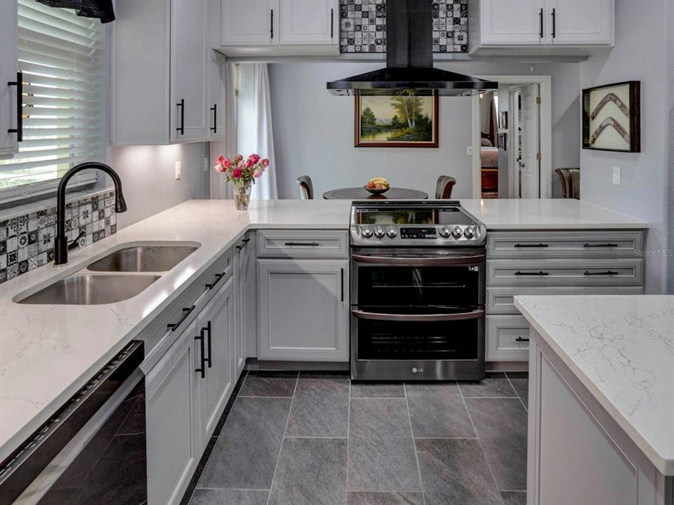 Kitchen with Kraftmaid with Quartz countertop.