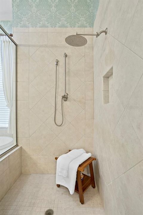 Primary bath with hand held and rain shower head.