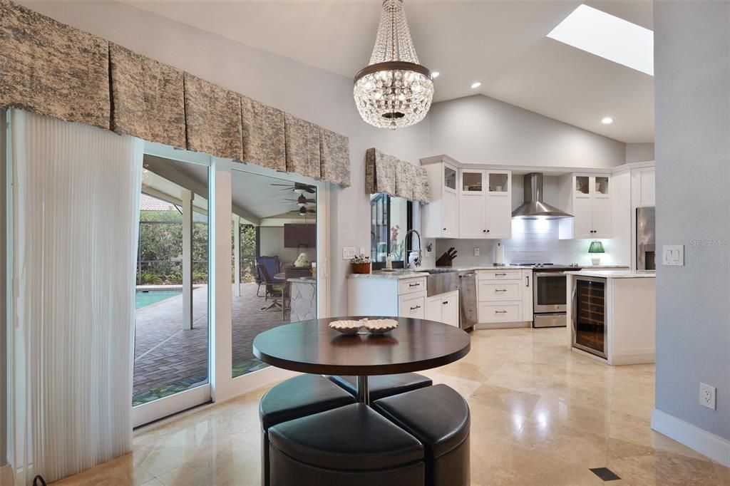 Family room with beautiful fireplace high ceilings open to the kitchen.