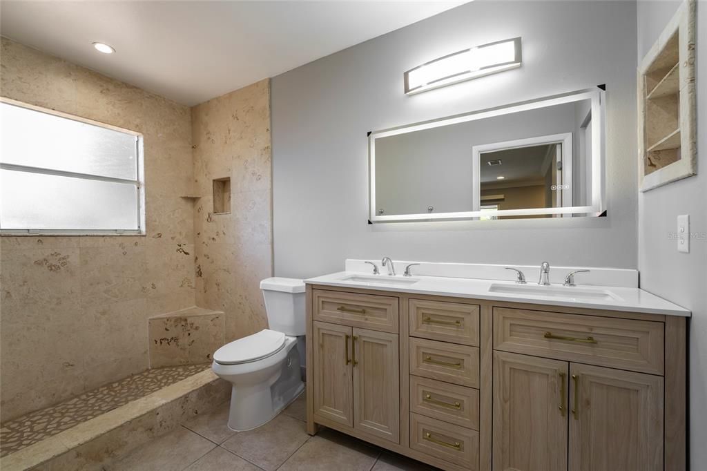 Master bath boasts travertine shower and floors, plus NEW dual sink vanity.