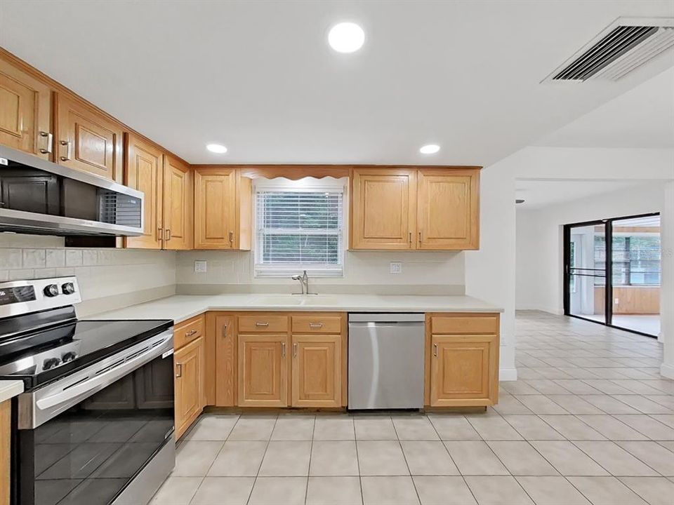 Eat-in Kitchen with NEW Stainless Appliances, lighting, window treatments, and cabinetry hardware.