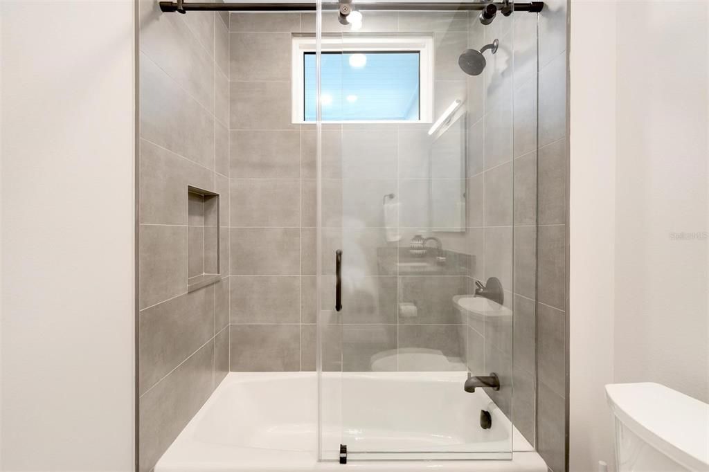 Guest bathroom tub and shower.