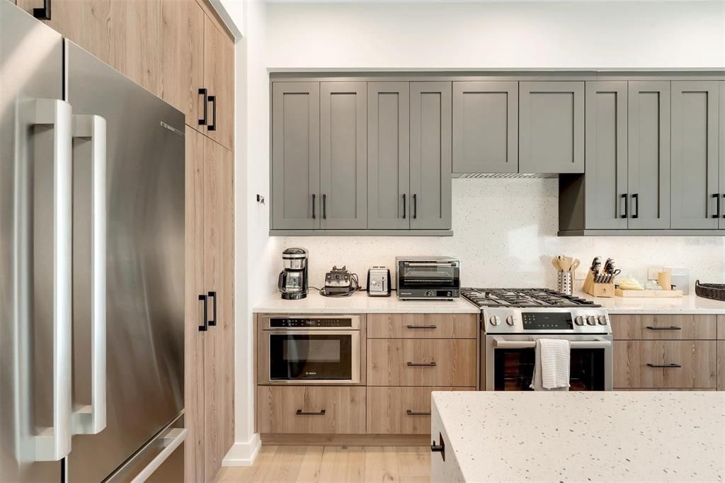 The pantry cabinetry is located on the right side of the refrigerator.