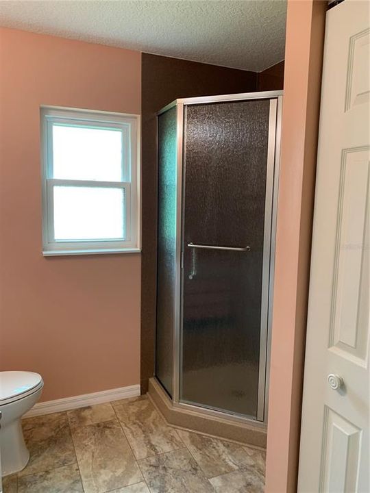 Corner walk-in shower in master bath, nice flooring