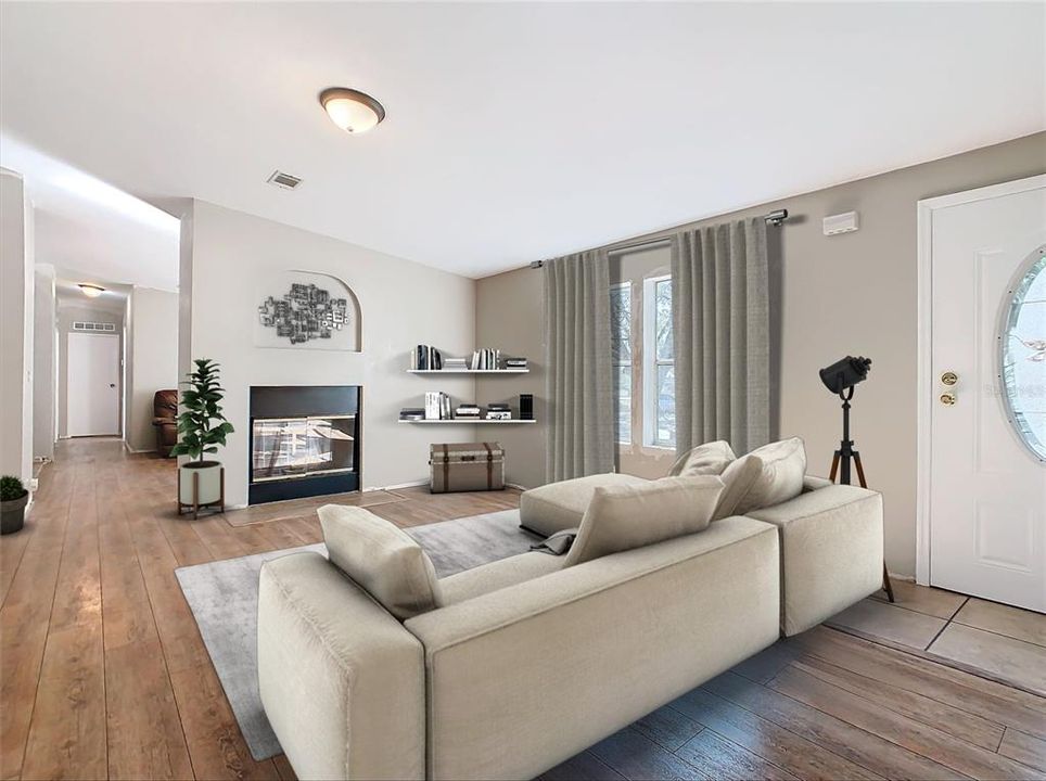 Staged living room (1 of 2 living areas) double sided wood burning fire place.