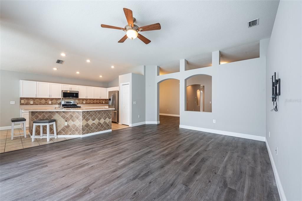 The kitchen features newer stainless steel appliances including a gas range, lots of cabinet storage & counter prep space, a large center island and a nearby eat-in area.
