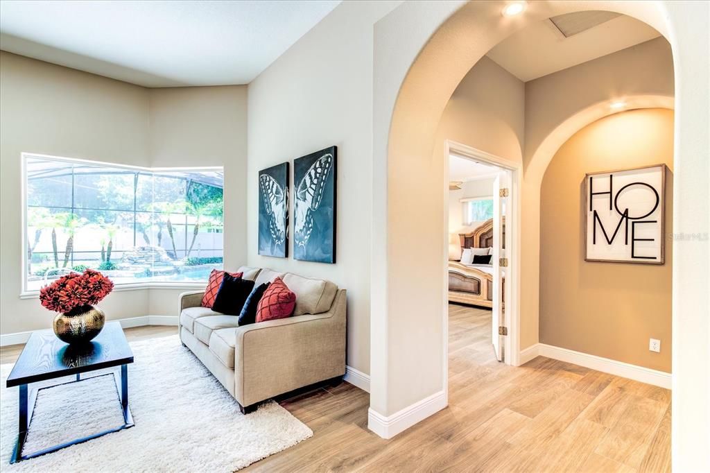 Living room which leads to primary bedroom area.