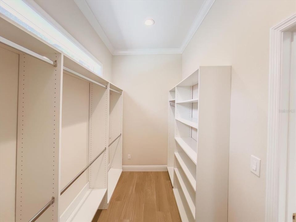 Primary suite has double walk-in closets.