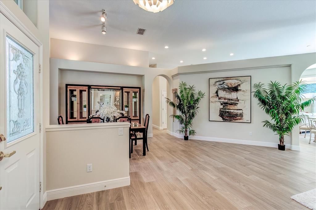 Foyer looking into living room and dining area.