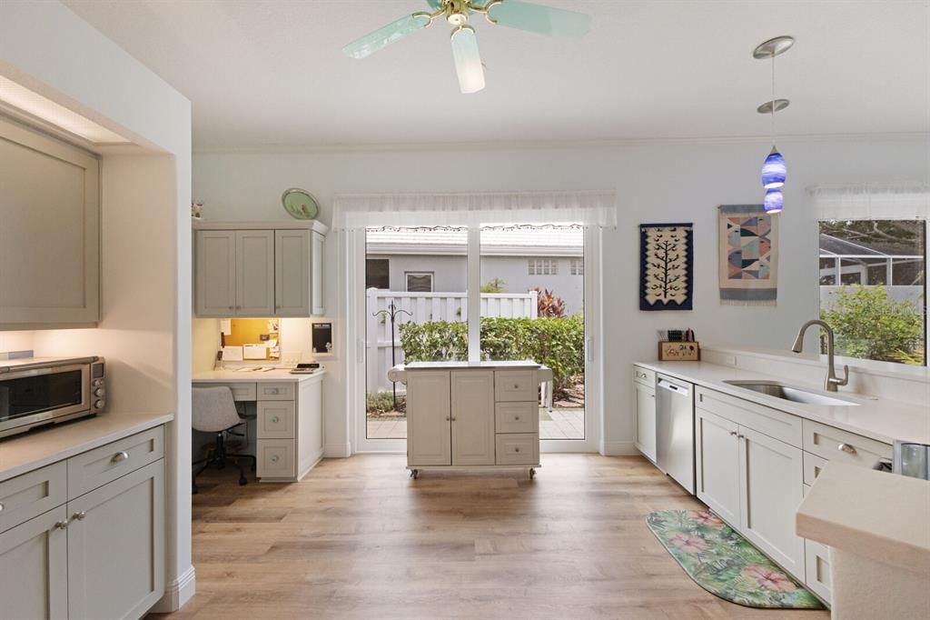 Spacious kitchen layout with new sliding glass doors leading to the side courtyard